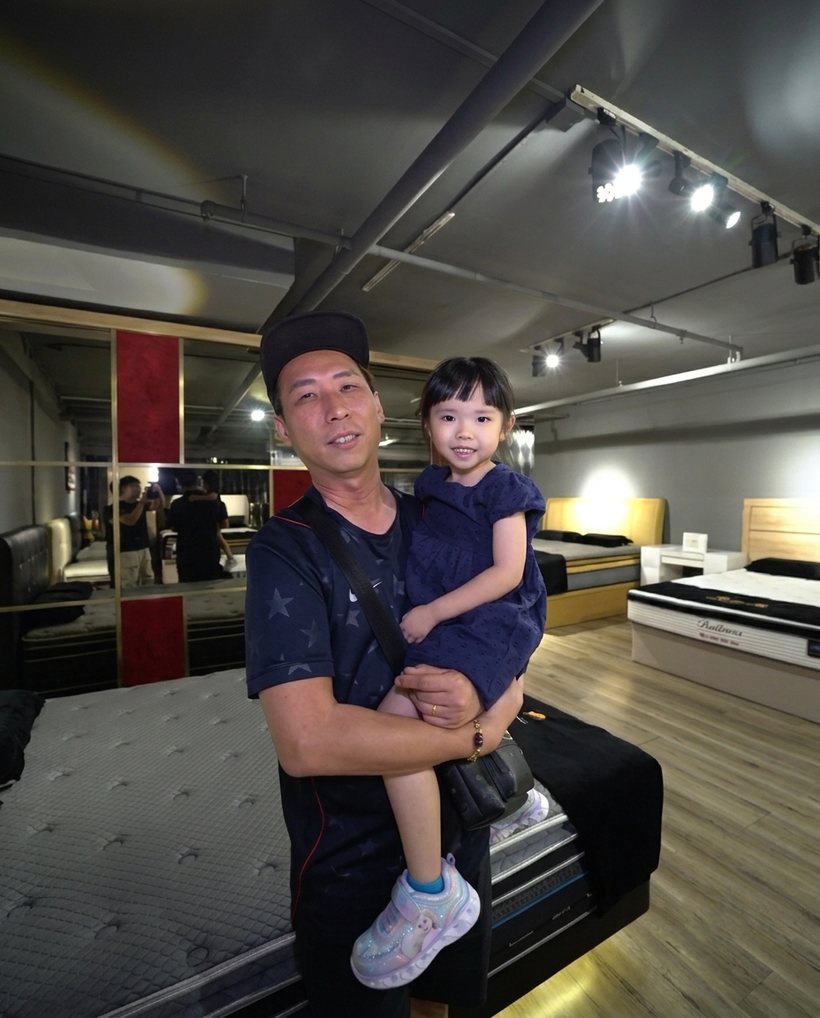Happy customer and child at the Furniture Depot showroom