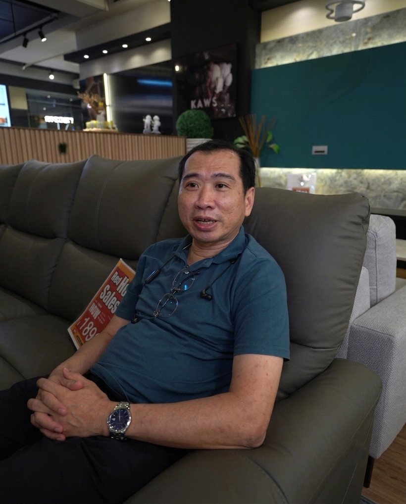Happy customer at the Furniture Depot showroom